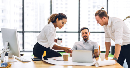 Group of professional business meeting and discussing strategy with new startup project.Creative business people planning and brainstorm with laptop computer in modern workloft.Teamwork concept