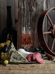 Rustic still life with white wine and snacks.