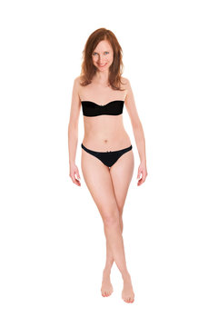 Full length portrait of an attractive woman wearing black bra and panties