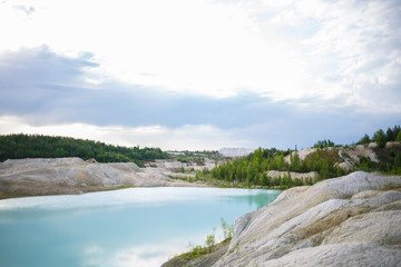 Aerial spectacular view to scenic valley with beautiful mountain lake, conifer forest and rocky mountains. Amazing atmospheric highland landscape. Wonderful majestic wilderness nature scenery.