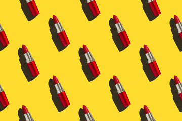 Red lipstick on colored background in pop art style with copy space for print. Red lipstick on a bright yellow background. Seamless pattern. Perfectly retouched photo