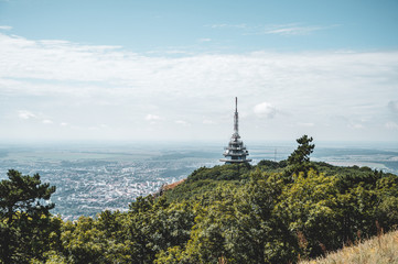 View of TV, radio and BTS tower called Pyramida from Zobor hill, center of Nitra city and rapeseed fields in background. Location Zobor hill, Nitra, western Slovakia