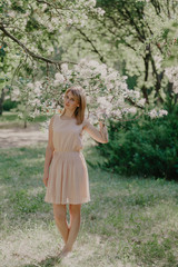 Fototapeta na wymiar Girl barefoot in a summer garden on the grass