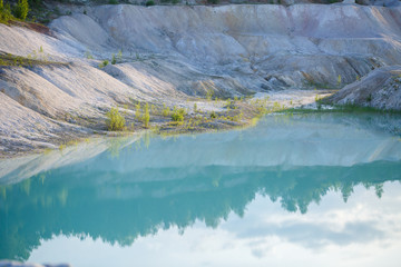 Aerial spectacular view to scenic valley with beautiful mountain lake, conifer forest and rocky mountains. Amazing atmospheric highland landscape. Wonderful majestic wilderness nature scenery.