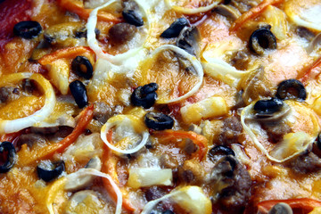 Freshly made pizza with cheese, tomato sauce, vegetable and meat toppings