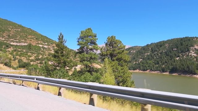 Slow motion pov point of view driving in vehicle car on scenic road in Colorado on Million Dollar Highway 550 at San Juan national forest with canyons on route from Ouray to Durango