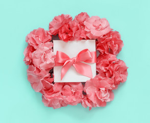 White gift box between pink flowers