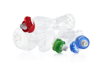Pile of crumpled bottles isolated on white. Plastic recycling