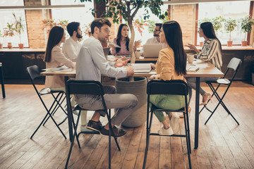 Photo of business people colleagues sit around table members share successful anti crisis crash plan ideas team professionals discuss graphics charts 2020 pre budget numbers office indoors