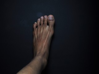 Close-up male feet isolated on black background