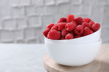 Delicious fresh ripe raspberries on grey table. Space for text
