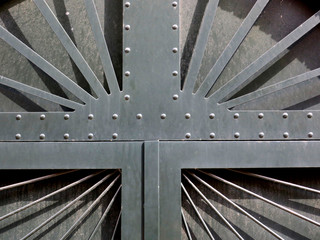 detail of a green iron door with spikes and nails