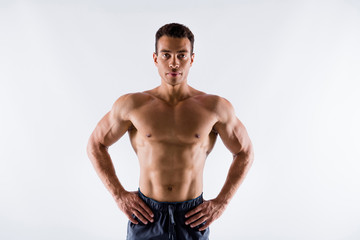 Portrait of his he nice attractive serious sportive virile tanned guy ripped shape figure professional experienced trainer coach fighter competitor isolated over light white pastel color background