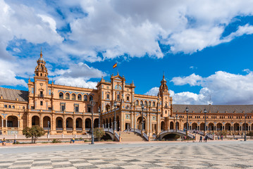 Fototapeta premium Seville, Spain. October 14th, 2019. Plaza de España with tourists strolling admiring the amazing palace and fountain.