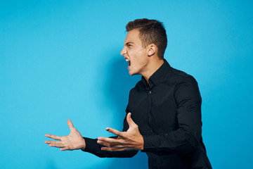 emotional man in black shirt studio lifestyle blue isolated background