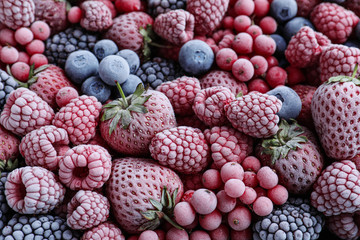 Mix of different frozen berries as background, top view