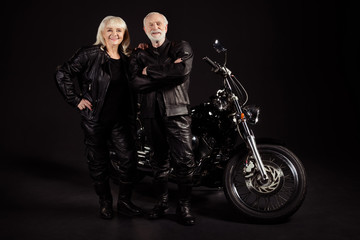 Obraz na płótnie Canvas Portrait of his he her she nice attractive cool content cheerful grey-haired couple travelers rebel rockers having fun chopper club lifestyle isolated over black color background