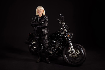 Naklejka na ściany i meble Portrait of her she nice attractive lovely content cheerful cheery grey-haired lady revel rocker chopper lover enjoying club life leisure hobby folded arms isolated over black color background
