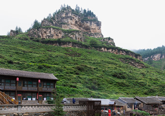 Mountain and houses at ancient Xuankong (hanging) or Wanghuagou Village built between cliffs in Mount Guancen of Luya Mountains, Ningwu County, Xinzhou, Shanxi, China.