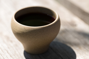Chinese tea ceremony. Ceramic teapot made of clay and bowls on a wooden background.