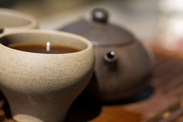 Chinese tea ceremony. Ceramic teapot made of clay and bowls on a wooden background.