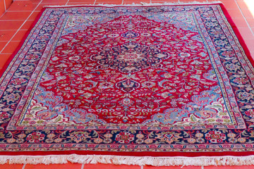 Thirty year old vintage woollen Persian carpet red and navy blue patterns