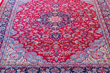 Thirty year old vintage woollen Persian carpet red and navy blue patterns