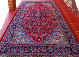 Thirty year old vintage woollen Persian carpet red and navy blue patterns