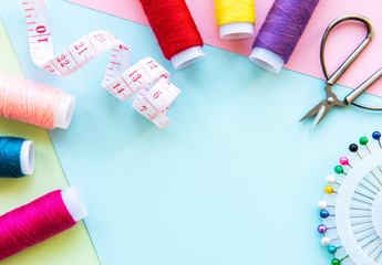 Sewing accessories on a blue pastel background