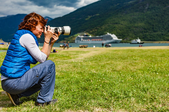 Woman take travel photo in Flam Norway