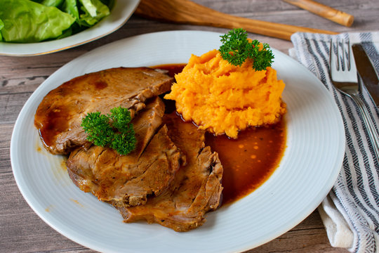 Roast pork with gravy and mashed sweet potatoes