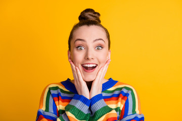 Portrait of astonished positive girl look wonderful novelty impressed touch face hands cheeks cheekbones wear sweater isolated over shine color background