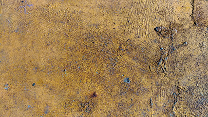 Textured rusty metal surface with yellow shades 
