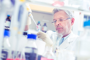 Life scientist researching in laboratory. Life sciences study living organisms on the level of...