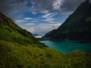 Fototapeta na wymiar Scenic view on Wasserfallboden See near Kaprun, Austria, Europe. National park Hohe Tauern. Charming lake with amazing deep colorful water and wild clouds on sky.