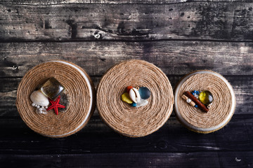 jewelry boxes on a wooden background. Round boxes decorated with marine attributes