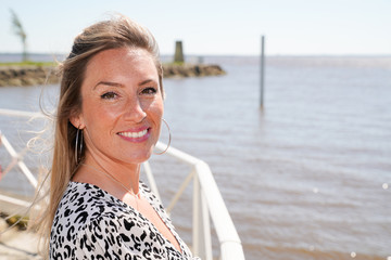 blonde beautiful woman on a seafront promenade during vacation