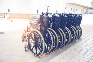 Rows of wheelchairs parking for disability patient services in medical hospital with copy space. Group of wheelchairs Row service at hospital