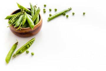 Sweet green peas in bowl on kitchen table desk