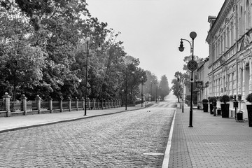 Black and white versionGrodno, Belarus, August 05, 2020: One of the old streets of the city in an early foggy morning.