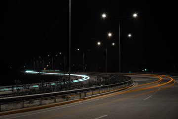 Car light trail long exposure at highway orange lights