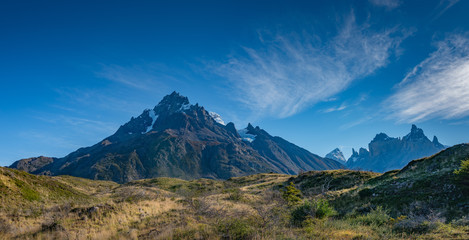 Panoramic view over magical mountain peaks standing high towers teeth surrounded by wet austral forests in Torres del Paine National Park, Patagonia, Chile, details