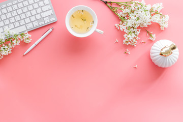 Workplace with laptop and flowers bouquet top view