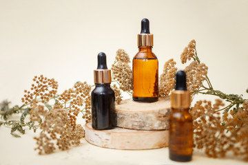 Dropper glass bottle skincare essential oil products for mock up in minimal style with on pastel cream background