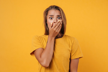Image of blonde shocked woman posing and covering her mouth