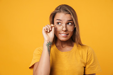 Image of blonde surprised woman in eyeglasses looking aside