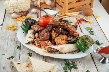 Big grilled barbecue platter meat and vegetables