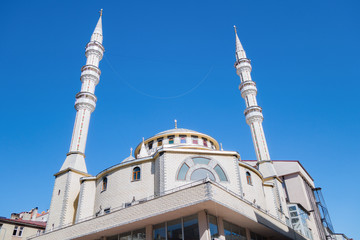 Urban mosque of Hz Ali Charshi (Ali Çarşı) brightly lighted by morning sun rays, Kars, Turkey. Building & its minarets built in traditional Ottoman style as imitation of Aya Sofya in Istambul