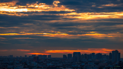 The high angle background of the city view with the secret light of the evening, blurring of night lights, showing the distribution of condominiums, dense homes in the capital community