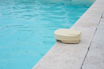 Swimming pool alarm on the side of a domestic pool